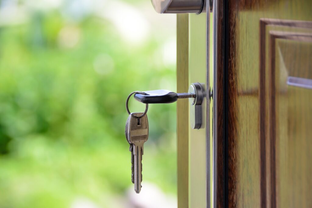 house key inserted in the front door - featured image